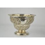 An Edward VII silver bowl, embossed with decorative fruit, flowers and leaf design, 17cm high,