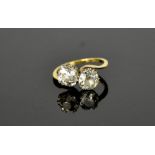 An 18ct gold 'Toi et Moi' diamond crossover ring, set with two large diamonds, each approximately