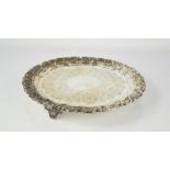 A silver salver by Goldsmiths & Silversmiths Co., embossed with floral scroll decoration and the