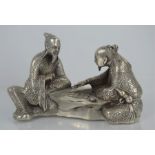 A vintage Chinese Miao silver statue of two gentleman playing chess, 816g. 17cm x 12cm