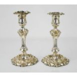 A pair of silver candlesticks with raised scrollwork, removable candles sockets, Sheffield 1822,