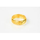 A 22ct gold wedding ring, with floral engraved decoration, 6.9g.