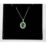 A 18ct white gold emerald and diamond pendant and chain, the emerald approx 1.2ct, the diamonds