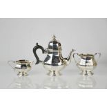A three piece Edward VII silver tea service by Henry Matthews, Birmingham 1906, of octagonal form,