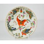 A Chinese dish, painted with various butterflies, blue character marks to the base, 13cm diameter.