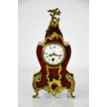 An early 20th century French tortoiseshell and gilt metal mantle clock, with Roman numeral dial,