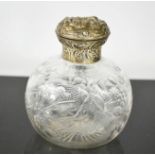 A silver topped dressing table bottle, by William Comyns, the body etched with birds and flowers,