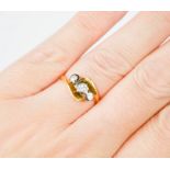 An 18ct gold and three stone diamond ring, size K.