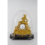 A 19th century French gilt metal mantle clock, cast with an artist model to the top, circa 1870,