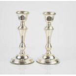 A pair of silver candlesticks.