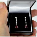 A pair of 18ct white gold diamond and ruby drop earrings, the rubies approx 0.5ct each