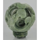 A Chinese large natural green jade five-ball handcarved concentric puzzle ball on stand dragon