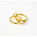 A 9ct gold charm in the form of an engagement and a wedding ring.