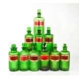 Ten green glass antique apothecary jars, with stoppers and latin labels, tallest measures 21cm