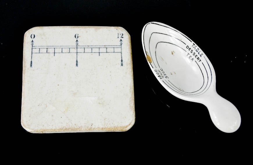 An antique pill tile, and a ceramic spoon measure.