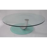 A contemporary designed glass coffee table, of circular form, with brushed chrome and opaque glass