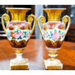 A pair of 19th century porcelain vases, hand painted with flowers, 20cm high.