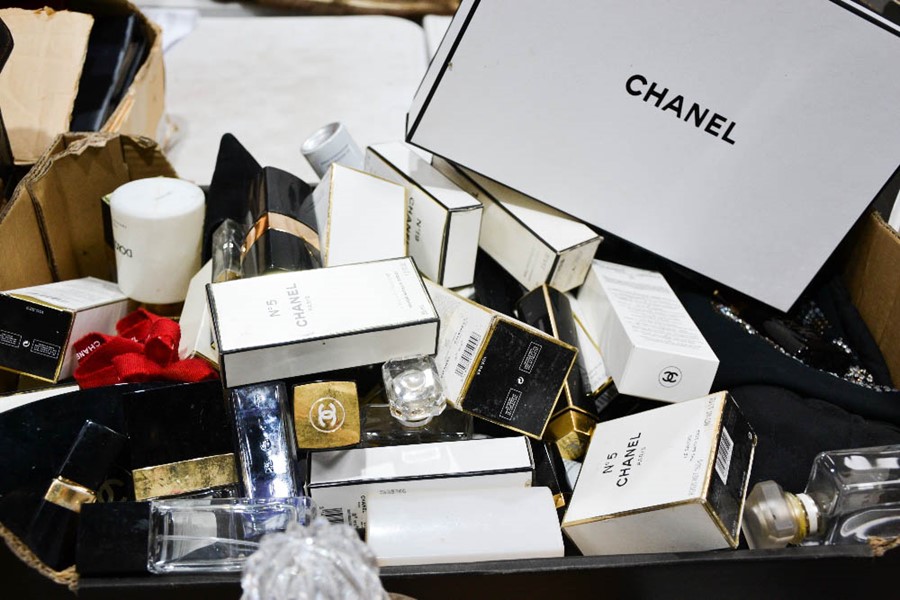 A group of Chanel boxes, perfume bottles, bags and other items.