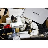 A group of Chanel boxes, perfume bottles, bags and other items.