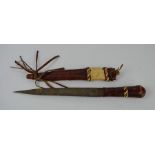 An early tribal dagger and sheath clad in red leather - blade length 19.5cm