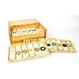 A boxed vintage set of specimen microscope slides, twelve drawers each containing at least six