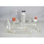 A group of chemistry equipment to include funnel, glass vials and other items.