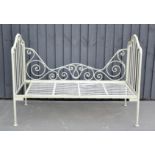 A French style painted day bed, with scrollwork frame.