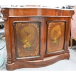 A Victorian mahogany serpentine credenza with marble top, and two shaped doors painted with birds