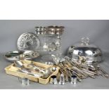 A group of silver plate ware to include domed meat cover, tureens, flatware, and wine coasters.