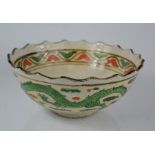 A vintage Japanese studio potter bowl signed to base depicting a dragon and sun