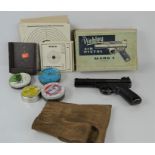 A boxed Webley mark 1 air pistol with a quantity of pellets and paper targets