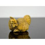A Chinese carved ivory netsuke, in the form of a cockerel, signed to the base, circa 1900, 3cm