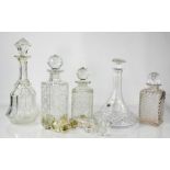 A group of cut glass decanters and stoppers, various style and form.