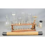 A group of glass measures, test tubes and rack, vials, and other chemistry glassware, tallest 20cm