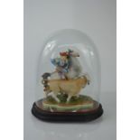 A continental figure of a matador on horseback in a glass cover