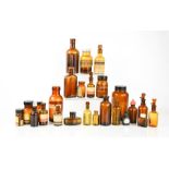 A group of vintage brown glass medicine bottles and jars.