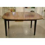 A G-Plan Tola & Black extending dining table, stamped 218 and bearing G-Plan label.