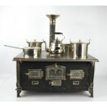 A 19th century children's working stove, German made, including kettle and saucepans.