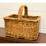 A vintage wicker basket with leather bound handle.