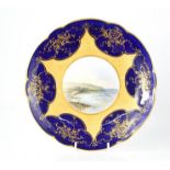 A 19th century Coalport porcelain plate, with cobalt blue ground and central hand painted vista of