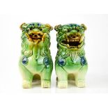 A pair of 20th century ceramic Chinese dogs of fo, 19cm high.