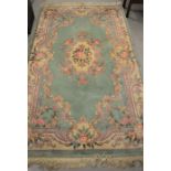 A Chinese green floral pattern handmade rug - 150cm x 248cm