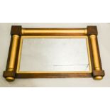 A mahogany overmantle mirror with gold painted columns.