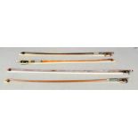 A group of four violin bows, one by Golden Strad.