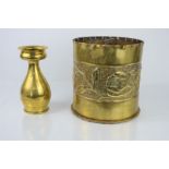 A large wwi trench art shell together with a further example in the shape of a vase