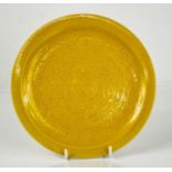 A Chinese yellow ground plate, inscribed with decoration and bearing six character mark to the base,
