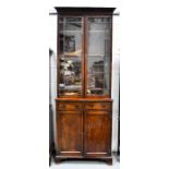 A Georgian mahogany bookcase, with glazed upper section enclosing height adjustable shelves, the