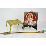A vintage tile titled Winter, together with a brass kettle stand and toasting fork.