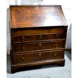 An 18th century oak bureau, the fall front enclosing a fitted interior above long graduated drawers,