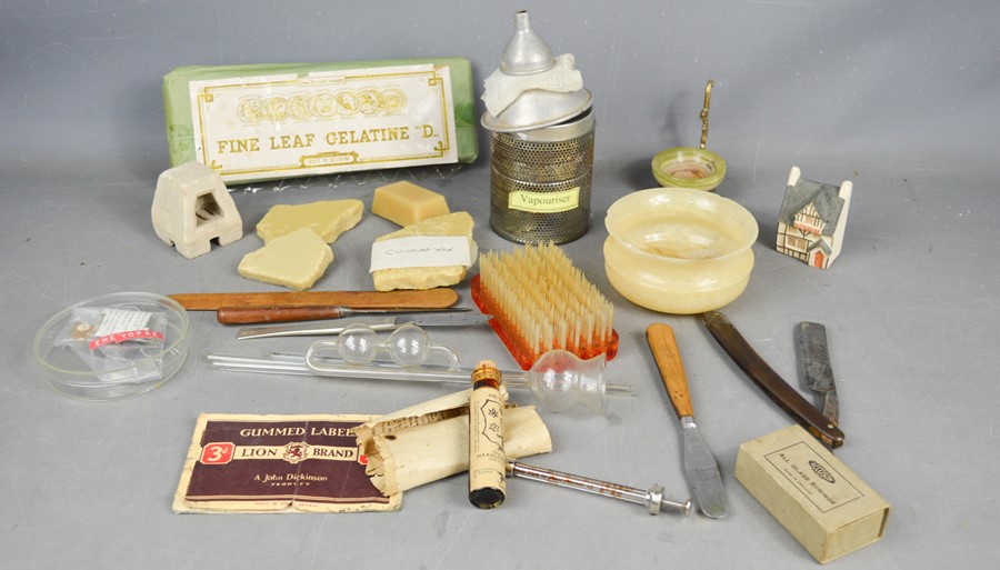 A group of vintage chemists collectables to include cut throat razor, carnauba wax, glass vials,